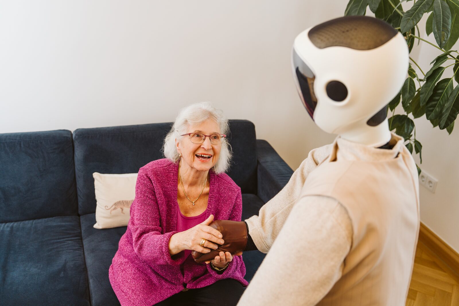 Senior woman laughing with Robody companion robot
